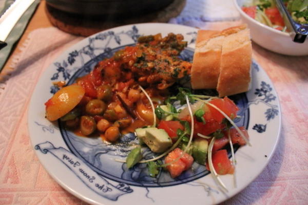 coxas de frango temperadas em caldo de tomate com azeitonas e grão de bico